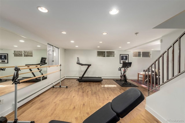 exercise room featuring baseboards, wood finished floors, and recessed lighting