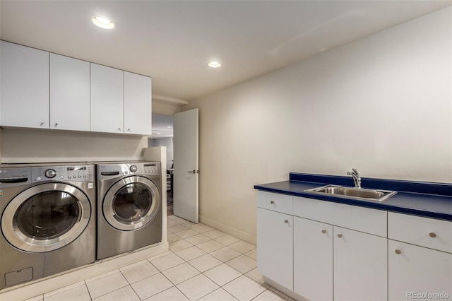 laundry area featuring recessed lighting, cabinet space, light tile patterned flooring, a sink, and separate washer and dryer