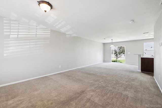 19209 E 58th Ave Unit C, Denver, CO 80249 - unfurnished living room with carpet flooring and baseboards