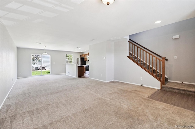 19209 E 58th Ave Unit C, Denver, CO 80249 - unfurnished living room with light carpet, stairway, and recessed lighting