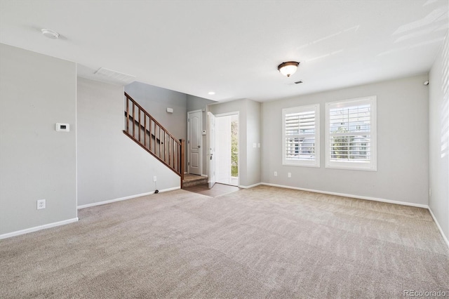 19209 E 58th Ave Unit C, Denver, CO 80249 - unfurnished living room featuring stairs and carpet flooring