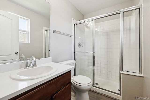 19209 E 58th Ave Unit C, Denver, CO 80249 - bathroom featuring a stall shower, vanity, and wood finished floors