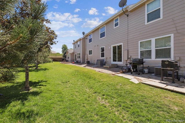 19209 E 58th Ave Unit C, Denver, CO 80249 - back of house with a yard and a patio area