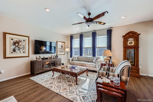 living room with dark hardwood / wood-style flooring and ceiling fan