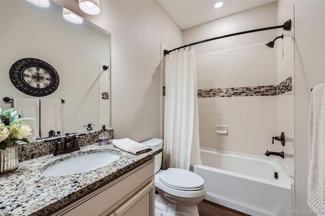 full bathroom with shower / tub combo, vanity, and toilet