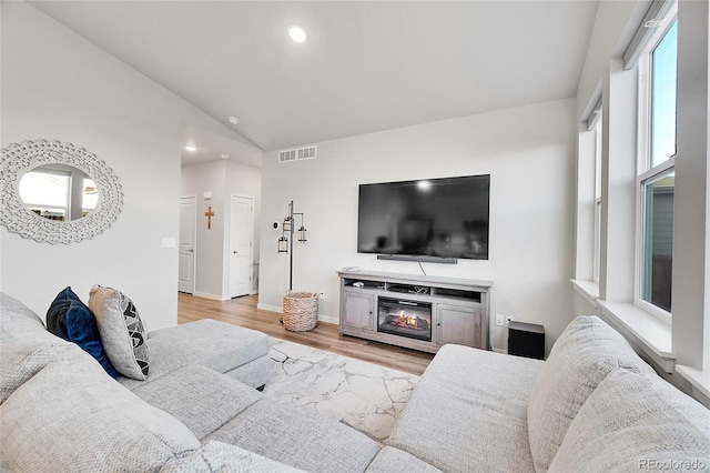 living room with lofted ceiling and light hardwood / wood-style flooring