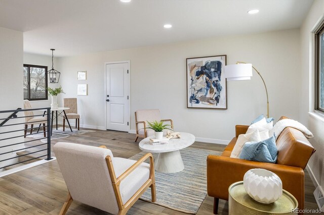 living area with baseboards, recessed lighting, and wood finished floors