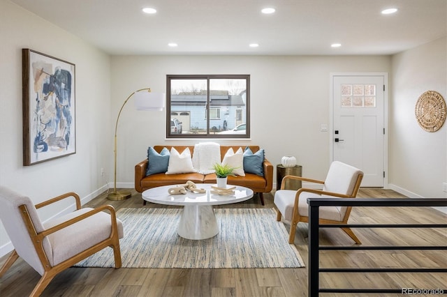 living area featuring baseboards, recessed lighting, and a healthy amount of sunlight