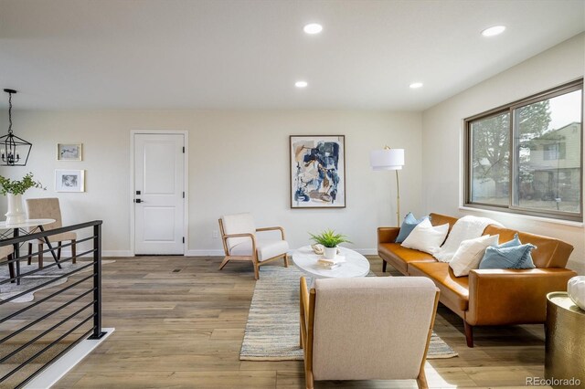 living room featuring baseboards, recessed lighting, and wood finished floors