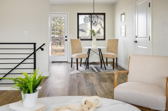 living area with baseboards and dark wood finished floors