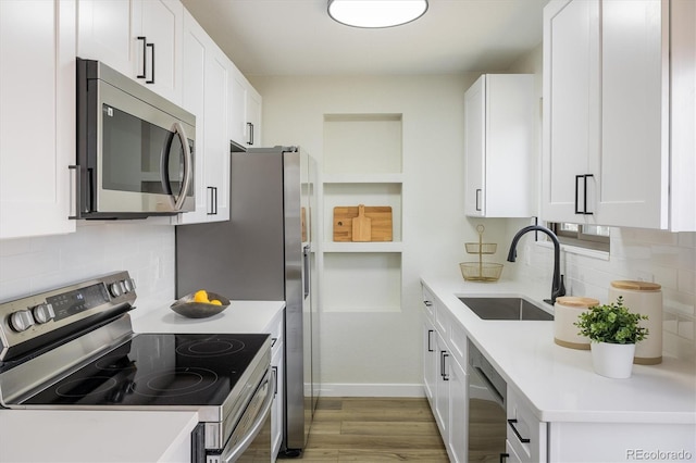 kitchen featuring white cabinetry, appliances with stainless steel finishes, and a sink