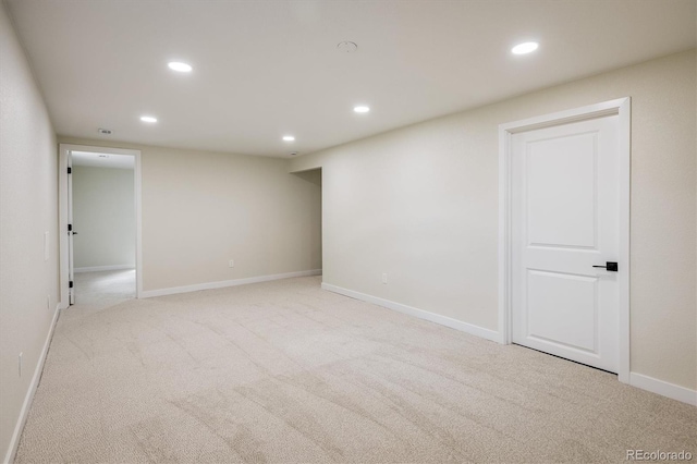 interior space featuring recessed lighting, baseboards, and light colored carpet