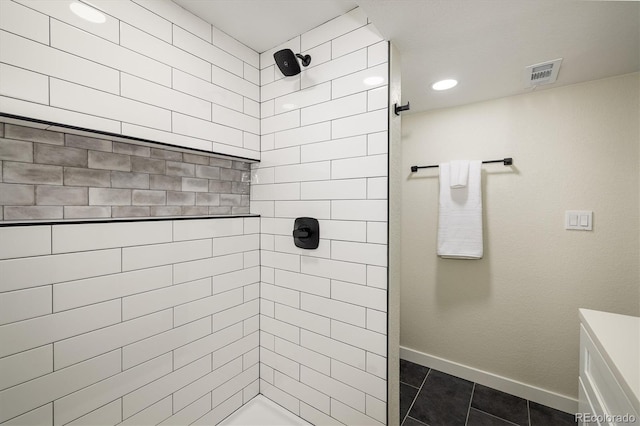 bathroom with a tile shower, tile patterned floors, recessed lighting, baseboards, and visible vents