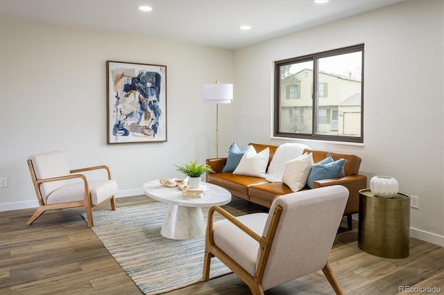 living area with baseboards, recessed lighting, and wood finished floors
