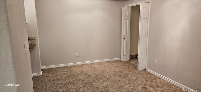 unfurnished bedroom with carpet flooring and baseboards