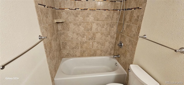 full bathroom featuring toilet, shower / bath combination, and a textured wall