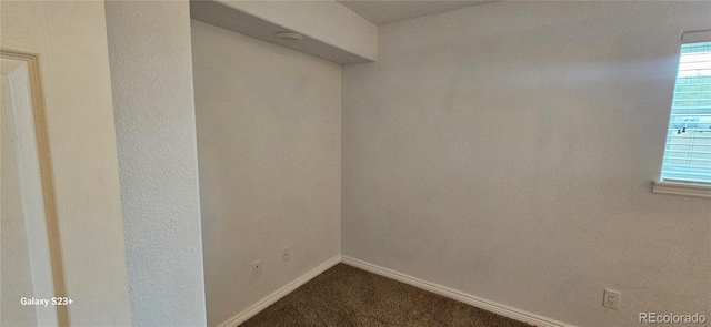 spacious closet featuring dark colored carpet