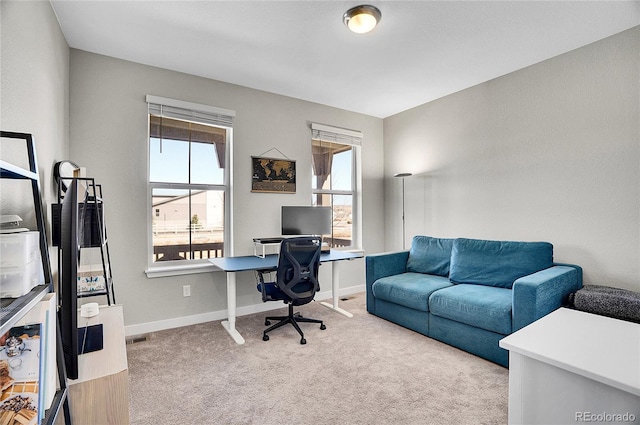 office with visible vents, baseboards, and carpet