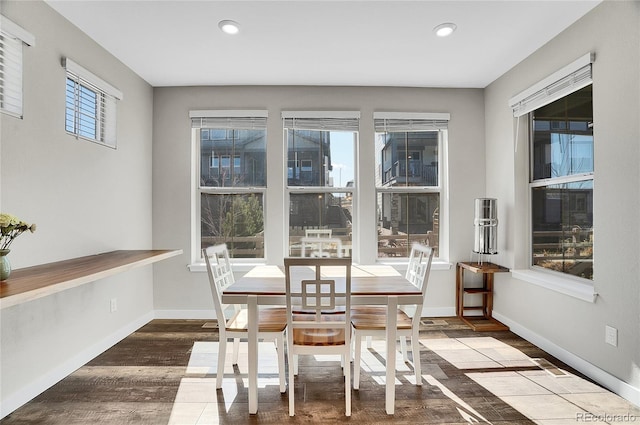 dining space with recessed lighting, baseboards, and wood finished floors