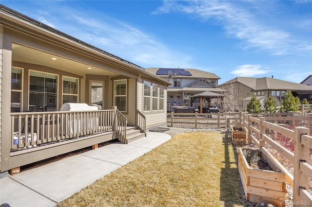 view of yard with a wooden deck, a residential view, and fence