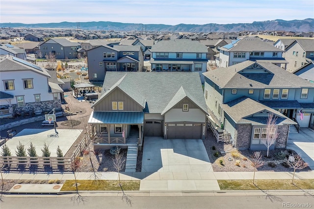 drone / aerial view with a residential view and a mountain view