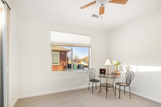 carpeted dining room featuring ceiling fan