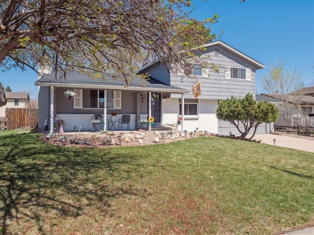 5945 W Morraine Ave, Littleton, CO 80128 - split level home featuring a porch, concrete driveway, a front yard, and fence