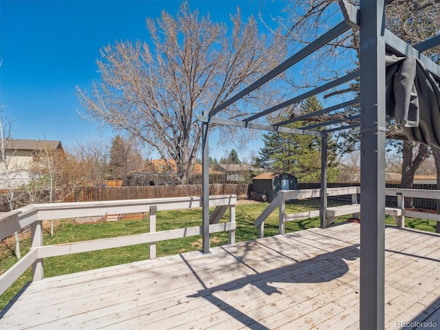 5945 W Morraine Ave, Littleton, CO 80128 - deck featuring a storage shed, a fenced backyard, a pergola, and an outdoor structure
