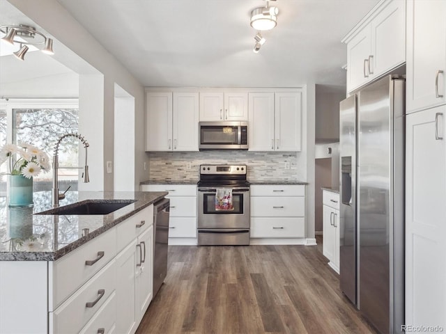 5945 W Morraine Ave, Littleton, CO 80128 - kitchen featuring white cabinets, a sink, dark wood-style floors, stainless steel appliances, and backsplash