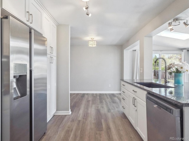 5945 W Morraine Ave, Littleton, CO 80128 - kitchen with baseboards, a sink, wood finished floors, dark stone counters, and stainless steel appliances