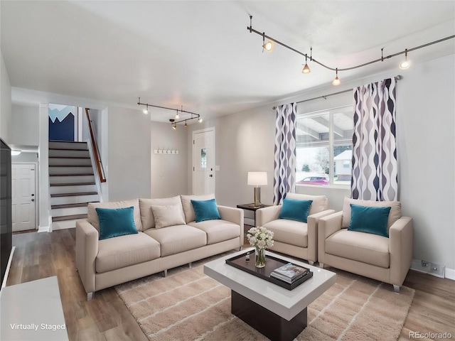5945 W Morraine Ave, Littleton, CO 80128 - living room with wood finished floors, baseboards, rail lighting, and stairs