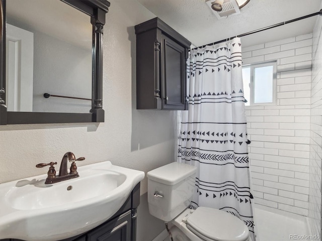 5945 W Morraine Ave, Littleton, CO 80128 - bathroom featuring a textured wall, curtained shower, vanity, and toilet