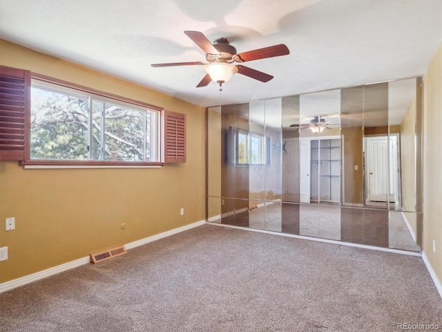 5945 W Morraine Ave, Littleton, CO 80128 - unfurnished bedroom with visible vents, baseboards, a ceiling fan, and carpet flooring