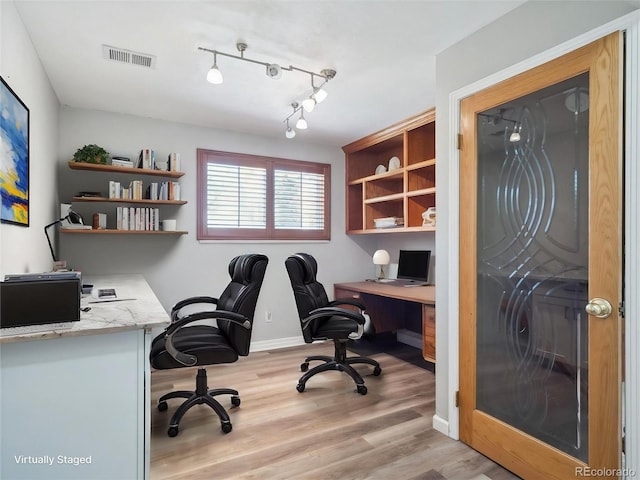 5945 W Morraine Ave, Littleton, CO 80128 - home office featuring built in study area, visible vents, light wood-type flooring, and baseboards