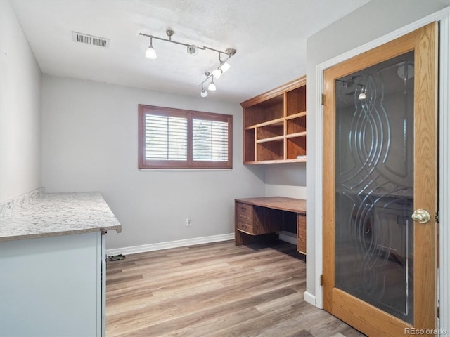 5945 W Morraine Ave, Littleton, CO 80128 - unfurnished office featuring visible vents, baseboards, and light wood-style floors
