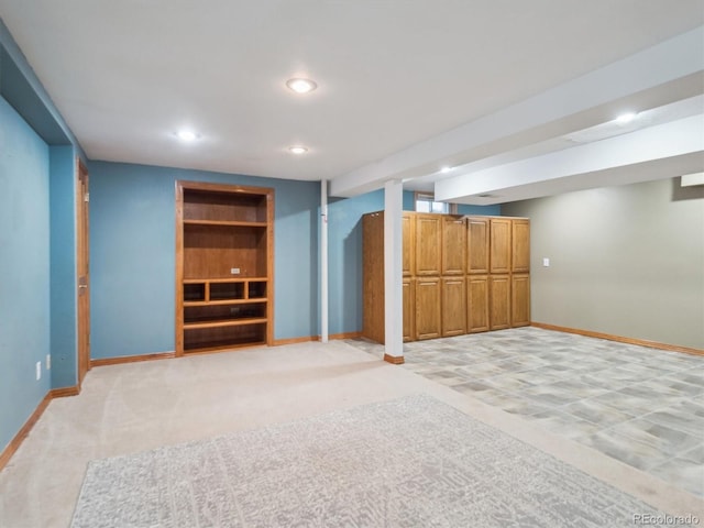 5945 W Morraine Ave, Littleton, CO 80128 - finished below grade area featuring light carpet, baseboards, built in shelves, and recessed lighting
