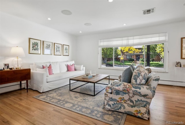 living area featuring visible vents, baseboard heating, wood finished floors, and recessed lighting