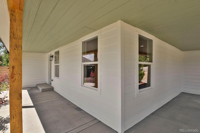 view of exterior entry featuring covered porch