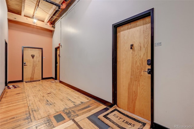 hallway featuring wood ceiling and light hardwood / wood-style flooring