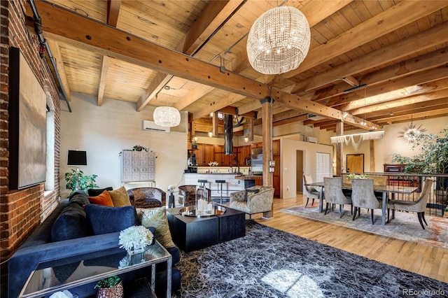 living room featuring beam ceiling, a notable chandelier, an AC wall unit, light hardwood / wood-style floors, and wood ceiling