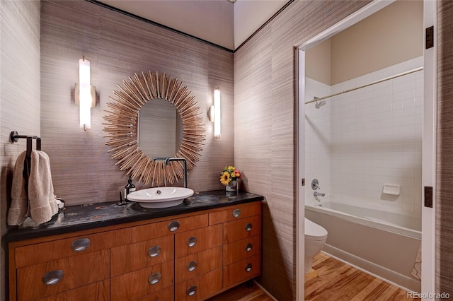 full bathroom featuring toilet, vanity, tub / shower combination, and hardwood / wood-style flooring