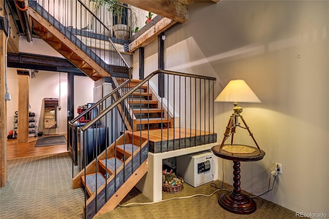 staircase with hardwood / wood-style flooring