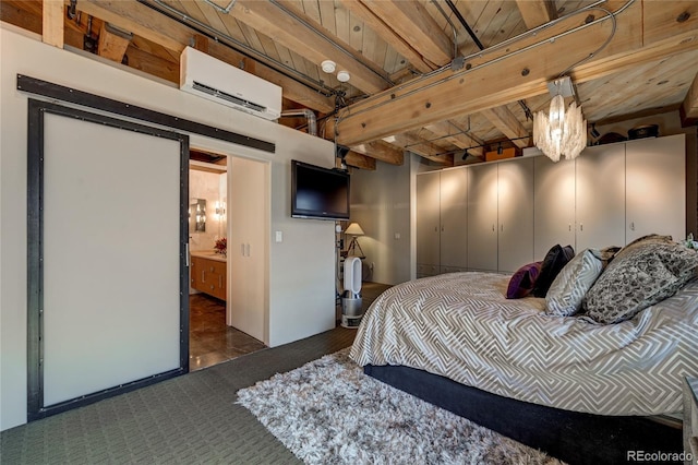 bedroom featuring ensuite bathroom and an AC wall unit