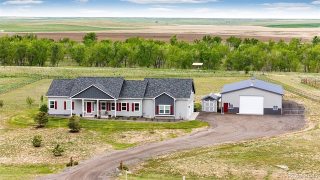 196 W 8th Ave, Byers, CO 80103 - view of front of home featuring an outdoor structure, a garage, a view of countryside, and driveway