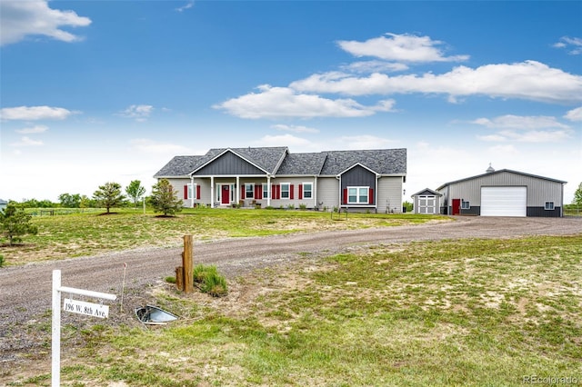 196 W 8th Ave, Byers, CO 80103 - single story home featuring an outbuilding, a detached garage, and a front lawn