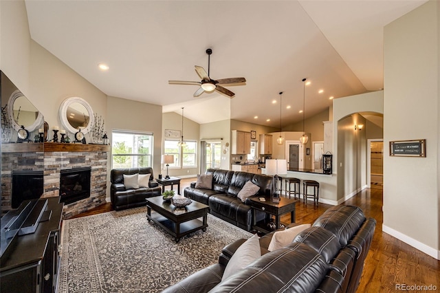 196 W 8th Ave, Byers, CO 80103 - living area with a ceiling fan, lofted ceiling, baseboards, arched walkways, and dark wood-style floors