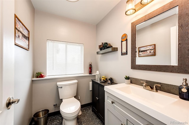 196 W 8th Ave, Byers, CO 80103 - bathroom featuring vanity, toilet, and baseboards