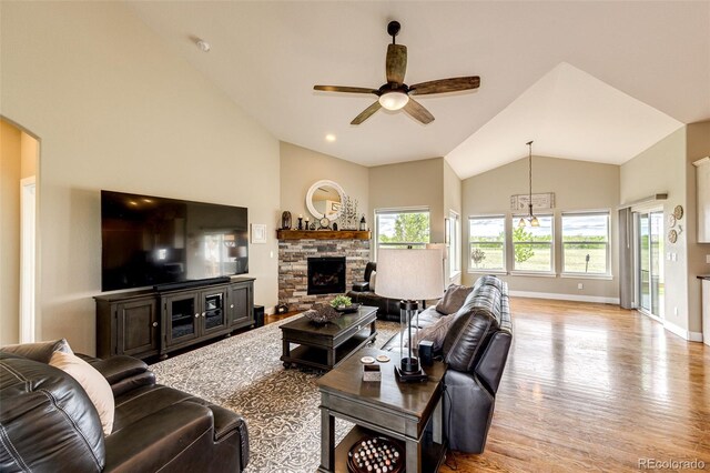 196 W 8th Ave, Byers, CO 80103 - living area featuring lofted ceiling, ceiling fan, wood finished floors, baseboards, and a fireplace