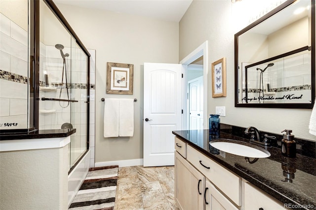 196 W 8th Ave, Byers, CO 80103 - bathroom featuring vanity, combined bath / shower with glass door, marble finish floors, and baseboards