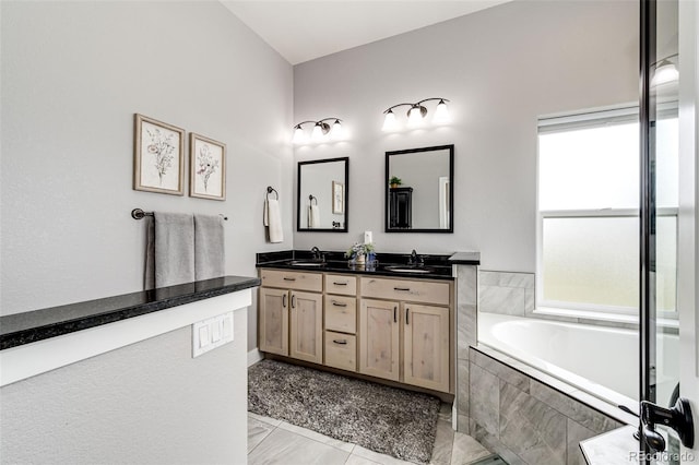 196 W 8th Ave, Byers, CO 80103 - full bathroom featuring a garden tub, double vanity, and marble finish flooring
